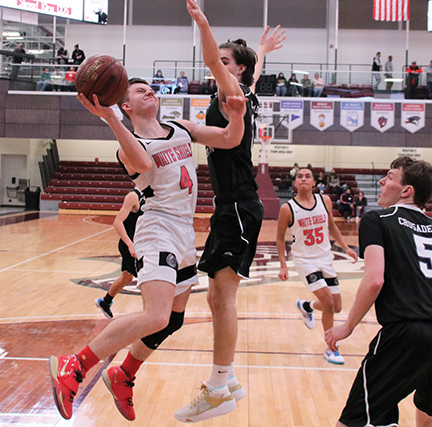 Issue9-BOYS DISTRICT Carson Calhoun of White Shield goes hard to the bucket with a defender in his face -rev-web