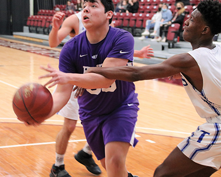 Issue9-BOYS DISTRICT Eddie Fixico of Parshall gets hammered hard by a Trenton defender as he tries to penetrate into the lane-rev-web