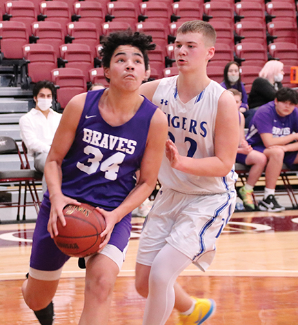 Issue9-BOYS DISTRICT Joaquin Powell of the Braves goes around his Tiger opponent on the right baseline in Saturday action in the region qualifier game -rev-web