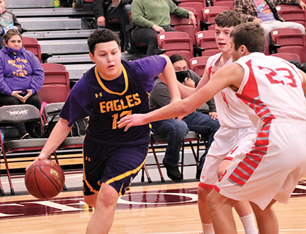 Issue9-BOYS DISTRICT New Town Eagle Charlie Hunter drove in the baseline against the tenacious defense of Alexander -rev-web
