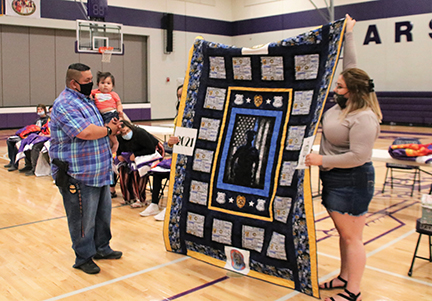 Issue-20STAR QUILT A SPECIAL QUILT WAS MADE AND PRESENTED TO A LOCAL POLICE OFFICER AT THE PARSHALL HIGH SCHOOL SENIOR STAR QUILT CEREMONY -REV-web
