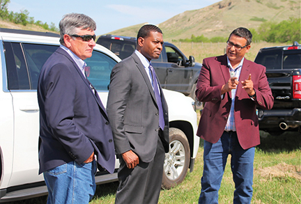 Issue23-MHA CHAIRMAN MARK FOX EXPLAINS SOME OF THE TRIBAL ENVIRONMENTAL PROTECTION MEASURES AT A DRILLING RIG SITE TO EPA DIRECTOR MICHAEL REGAN (CENTER) -REV-web
