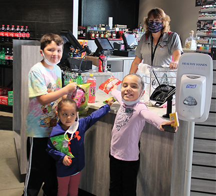 issue22-FOUR BEARS C STORE THREE OF THE FIRST EAGER CUSTOMERS AT THE FOUR BEARS CONVENIENCE STORE LIKE THE VARIETY OF CHOICES OF SNACKS -REV-web